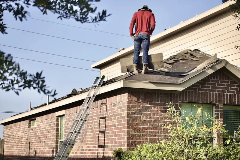 Professional roofer working on a residential roof in Piney Orchard